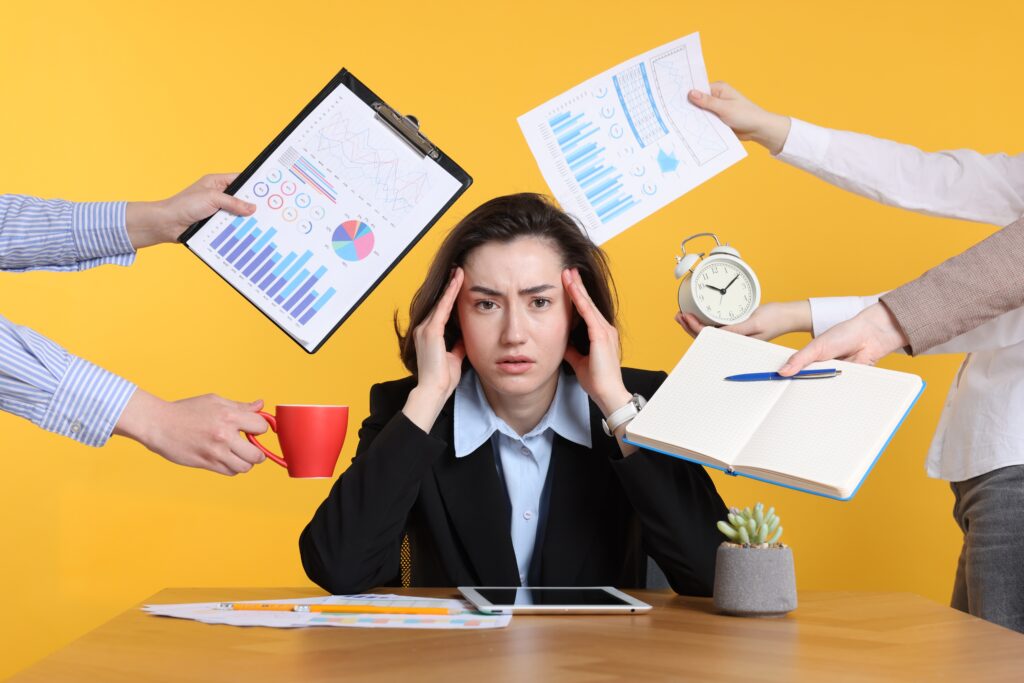 Emotional Overhead in Leadership executive with paper, clipboards, coffee, and a clock coming at her
